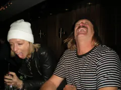 Two strangers fake laughing